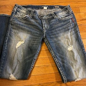 Distressed Seven Jeans.
